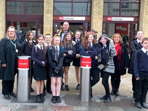 A photograph of a group of school children outside Cambridge Railway Station