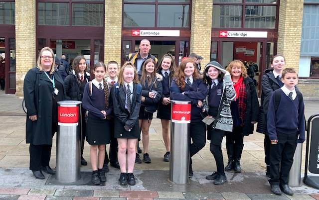 A photograph of a group of school children outside Cambridge Railway Station