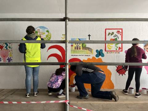 Children and adults painting a the wonderpass