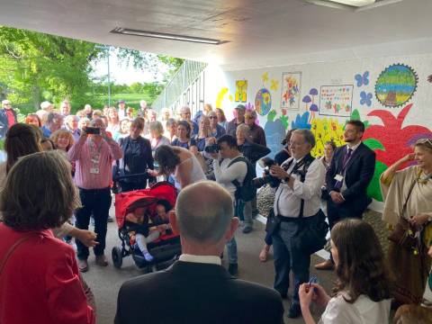 Crowd of people gathered to celebrate the Meldreth wonderpass mural
