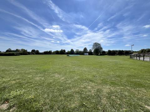 A photograph of the recreation ground at Foxton, including covers protecting the cricket pitch.