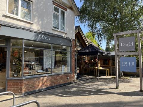 Image of the Deli in Shelford. Bike racks appear in the foreground.